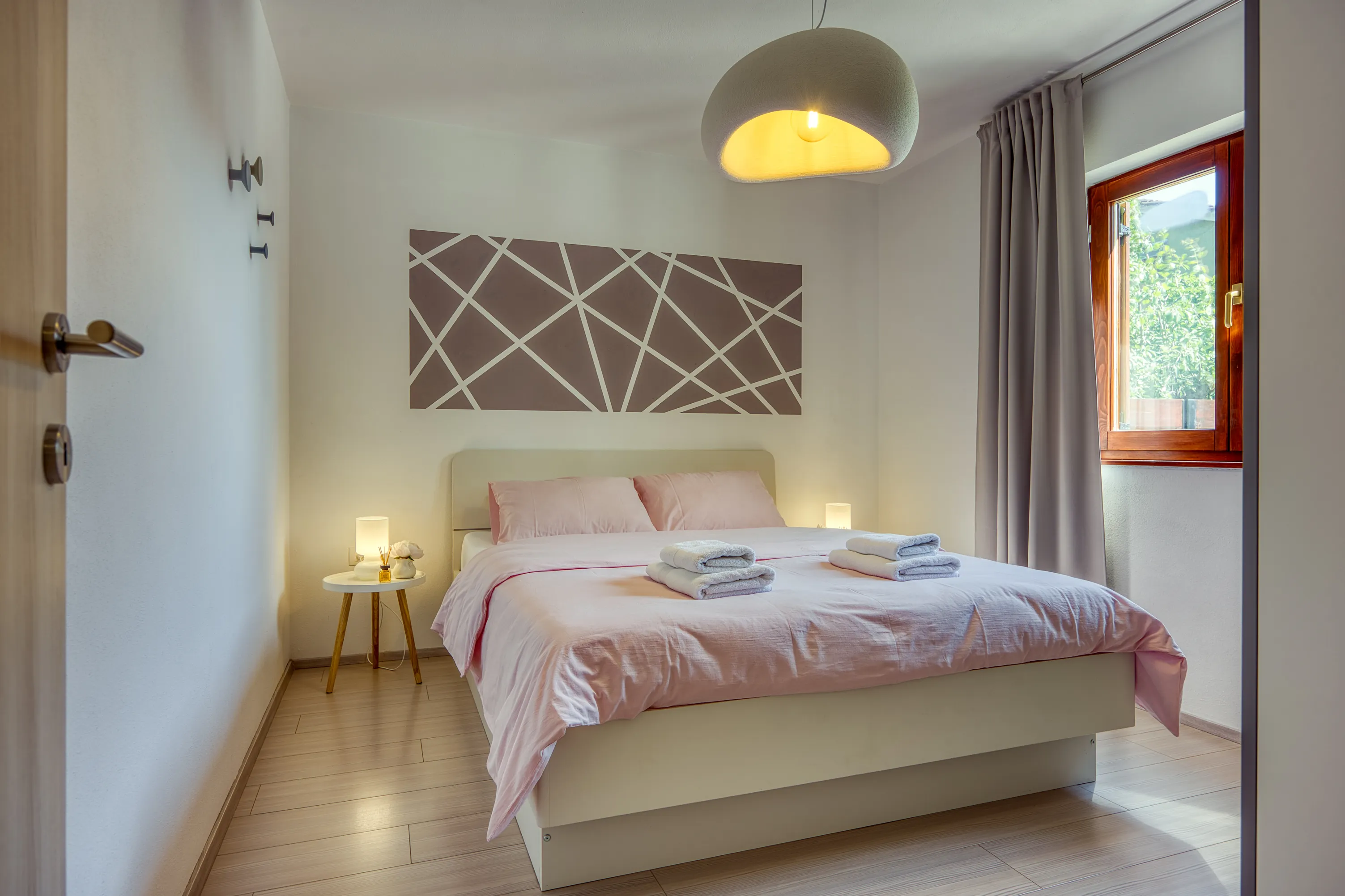 Double bedroom with warm wooden furniture